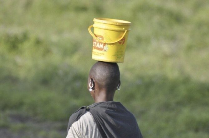 women carries water bucket